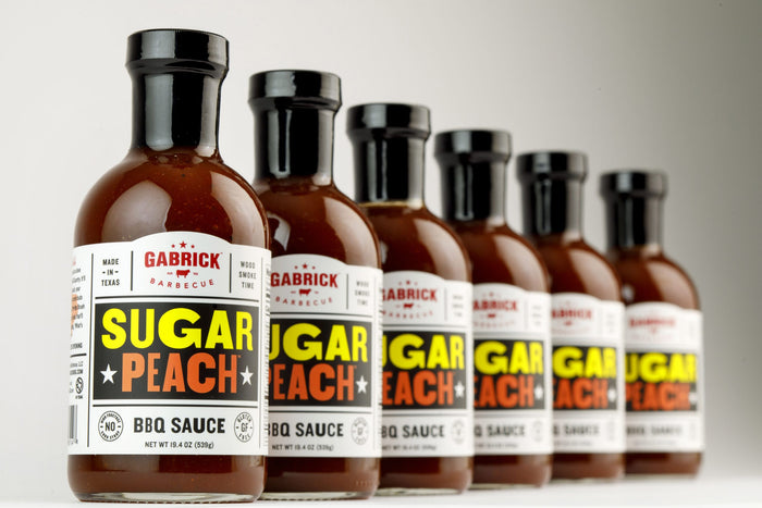 SUGAR PEACH BBQ SAUCE PHOTO OF 6 BOTTLES IN DIAGANOL PATTERN