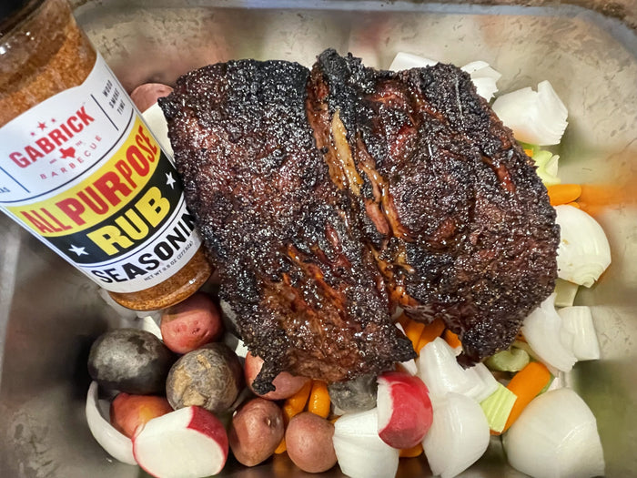 Seared chuck roast on wood-fired grill.